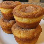 Stack of fluffy bakery-style cinnamon sugar muffins coated in a crisp cinnamon-sugar layer.