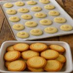 Homemade keto butter cookies with golden edges and swirl texture arranged in a bowl, low-carb and sugar-free.