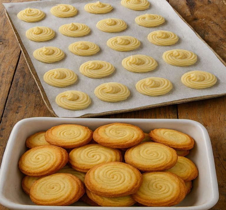 Homemade keto butter cookies with golden edges and swirl texture arranged in a bowl, low-carb and sugar-free.