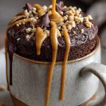 Keto choco peanut butter mug cake with melted peanut butter topping
