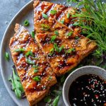 Keto teriyaki tofu steaks glazed with sugar-free sauce and topped with sesame seeds