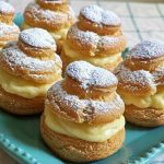 Keto cream puffs filled with vanilla cream and dusted with powdered sweetener