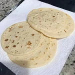 Soft zero-carb keto carnivore tortillas made with pork rinds, eggs, and cream cheese, cooked in a skillet and folded for tacos and wraps.