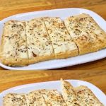 Keto low carb chicken pizza sliced into squares with creamy cheese topping